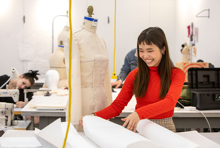 Student with clothing model. Links to Gifts by Will